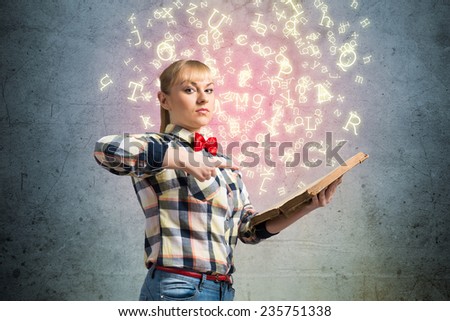 Young woman in casual with opened book in hands