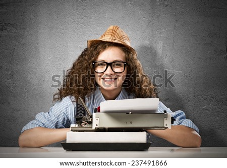 Young pretty woman writer with typing machine