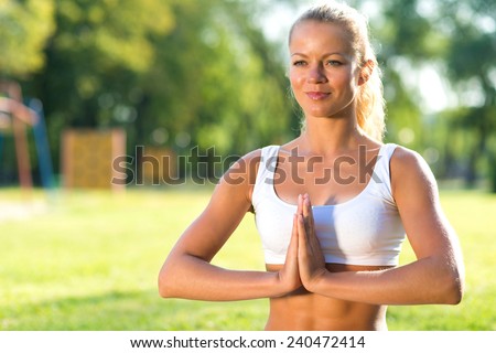 close-up portrait of a beautiful young girl doing yoga in the park