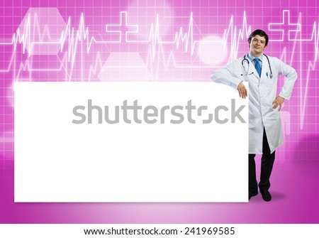 Young handsome doctor with white blank banner. Place your text