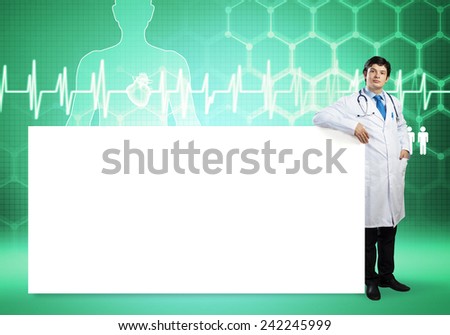 Young handsome doctor with white blank banner. Place your text