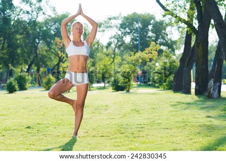 young attractive woman doing yoga in the park, active lifestyle