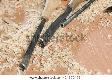 Close up of cutters for wood lying among sawdust