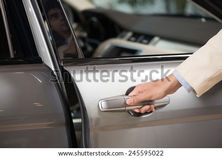 Close up of human male hand opening car door