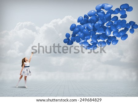 Cute girl of preschool age with bunch of balloons