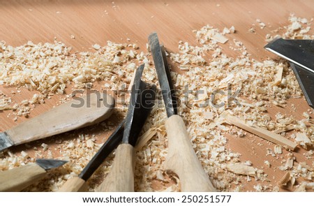 Close up of cutters for wood lying among sawdust