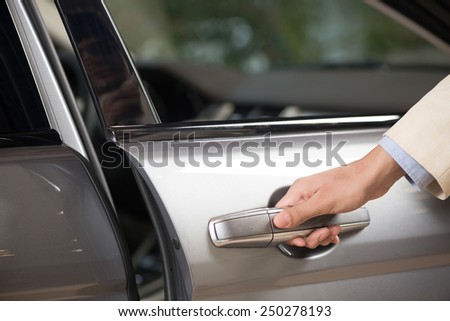 Close up of human male hand opening car door