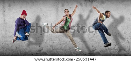 Group of dancer in jump on cement background