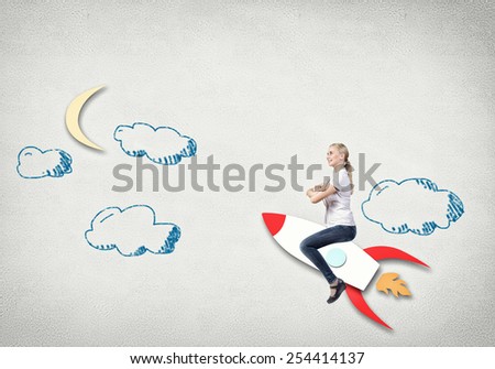 Young happy student girl riding drawing rocket