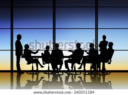 Silhouttes of business people as team sitting round table