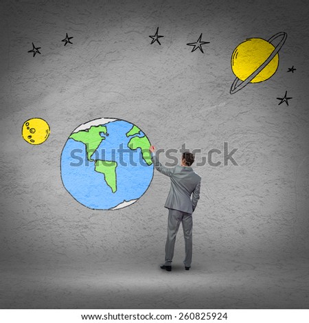 Rear view of businessman presenting drawn Earth planet
