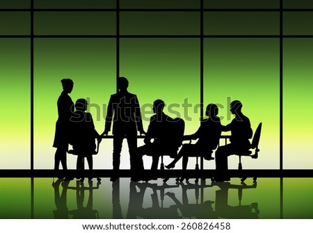 Silhouttes of business people as team sitting round table