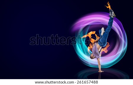 Modern style dancer in jump and lights at background