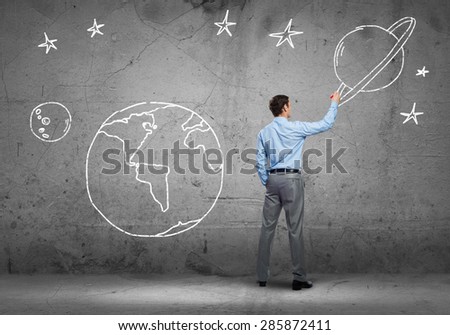 Rear view of businessman presenting drawn Earth planet