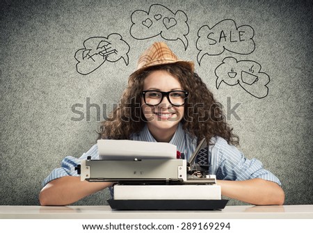 Young pretty woman writer with typing machine