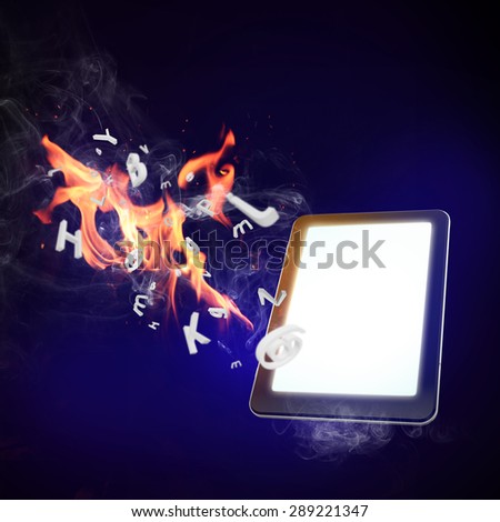 Conceptual image with mobile phone burning in flames