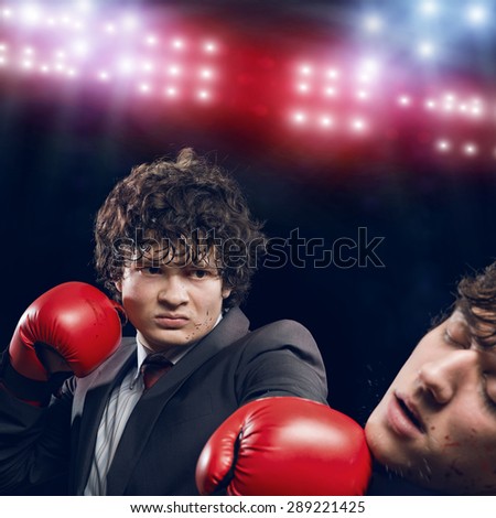 Two businessman with boxing gloves in the ring fighting with each other