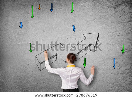 Rear view of businesswoman drawing increasing graph
