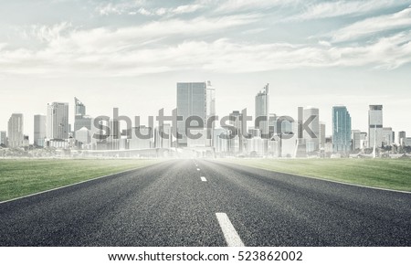 Natural landscape with asphalt road and modern city
