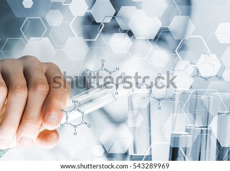 Young scientist mixing reagents in glass flask in clinical laboratory