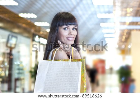 beautiful woman with shopping bags in the mall, Thinks about purchases