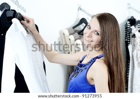 young Beautiful woman in mall buying clothes