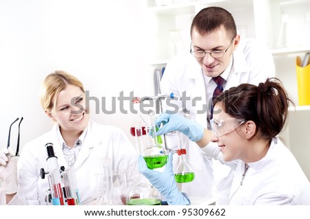 Chemists working with a team looking at the tube
