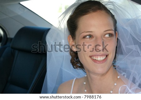 Beautiful bride sitting in the wedding car