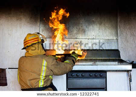 Fireman trying to put an oil fire out with a chopping board