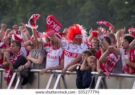 KRAKOW,POLAND-JUNE 8: Polish fans follow their team in the opening match of Eurocup 2012 against Greece in fanzone on June 8, 2012 in Krakow, Poland