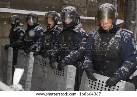 KIEV, UKRAINE - DECEMBER 11: police men defend the presidential palace as the protest continues despite the heavy snowstorm  on December 11, 2013 in Kiev, Ukraine