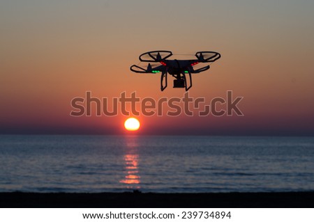 ITALY-OCT.30: DJI Phantom quadcopter flies against a beautiful sunset in the background  on the 30th of october ,2014 in italy. Quadcopter market is expected to pass the 20 billion in the 2020.