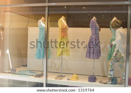 Mannequins at a window display women\'s fashion