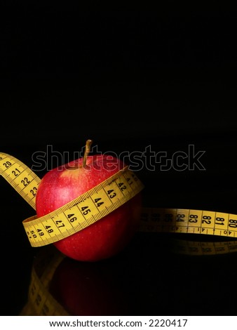 An apple with a measuring tape around as a concept of good food good healt