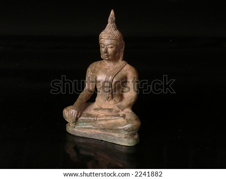 A buddhist statue isolated in a black background