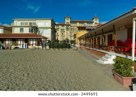 Viareggio\'s sandy beach with an old style hotel in the background