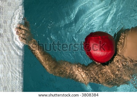 Swimming man touch the board of a pool. the photo has a conceptual meaning: reaching a scope,