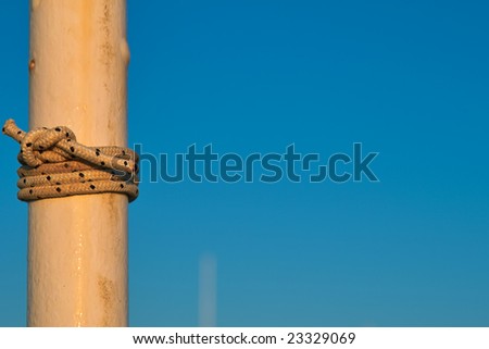 Close-up of rope on a wooden pole of a boat