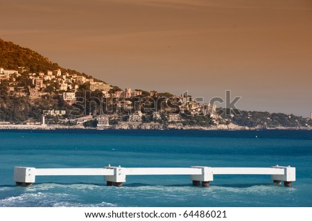 Old disused diving platform in the crystal clear water of Nice\'sea at sunset. Cote Azur, France