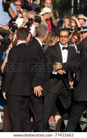 CANNES, FRANCE - MAY 16: Actor Brad Pitt says hello to fans at the  \'The Tree Of Life\' premiere during the 64th Annual Cannes Film Festival at Palais des Festivals on May 16, 2011 in Cannes, France