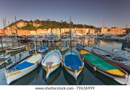 Old classic wooden boats and luxury yachts rest in the old port of Nice , cote azur, France