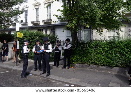 LONDON - AUG 29: police officers patrols the streets of Notting Hill during the traditional annual carnival ion August 29, 2011 in London, England.