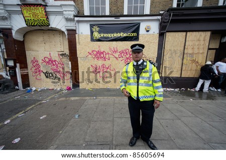 LONDON - AUG 28: policeman patrol the street of  Notting Hill during the famous annual caribbean  Carnival on August 29, 2011 in London, England.