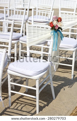 wedding ceremony, chairs decorated with bows