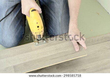 Man with Tools to Laying Laminate