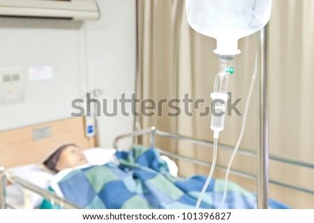 Senior woman patient in the hospital bed saline intravenous (iv) drip