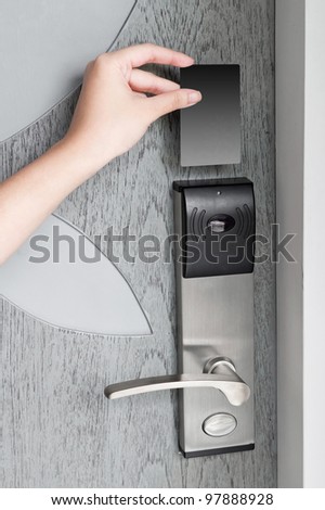 Hand holding hotel key card to enter the room