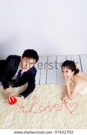 love couple spell word of love with ribbon