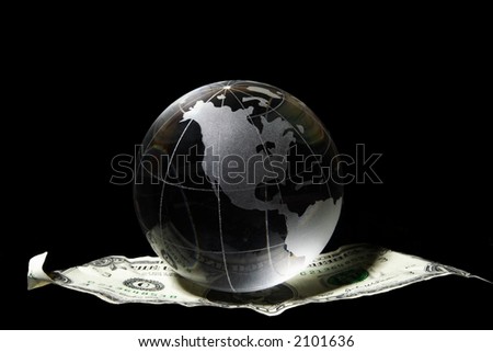 Transparent globe on a US dollar floating in black