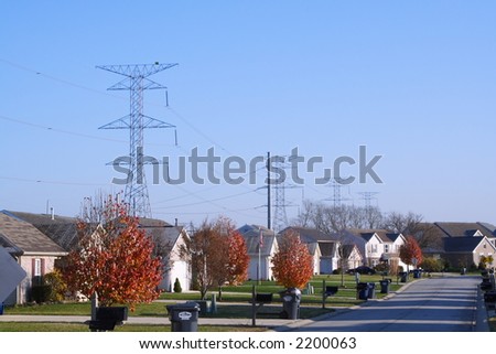 High voltage power lines crossing behind a suburban setting